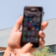 An Israeli woman uses her iPhone in front of the building housing the Israeli NSO group, on August 28, 2016, in Herzliya, near Tel Aviv.